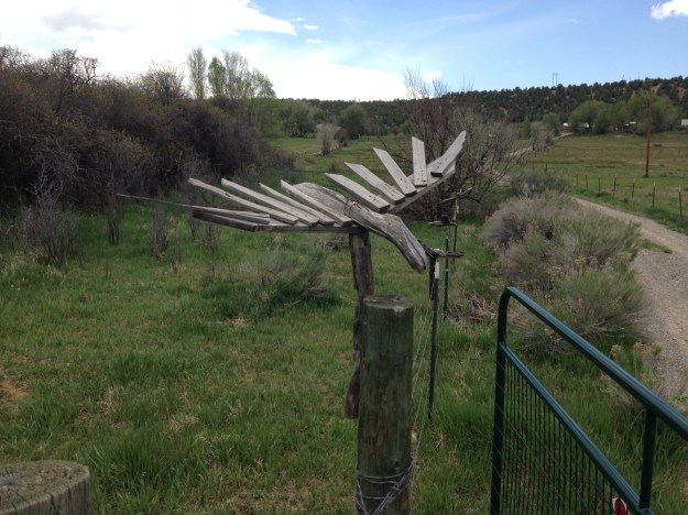 Crow sculptures on fence posts leading to main house
